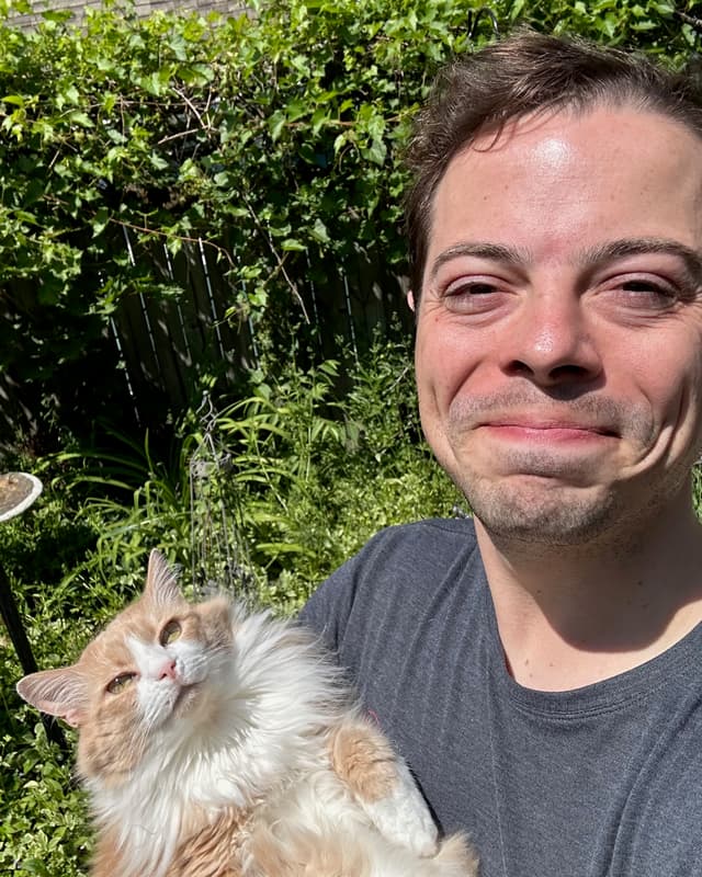 Picture of the author with his cat in the garden